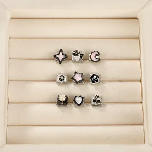 Close-up of diverse Italian modular bracelet charms with heart, star and animal motifs
