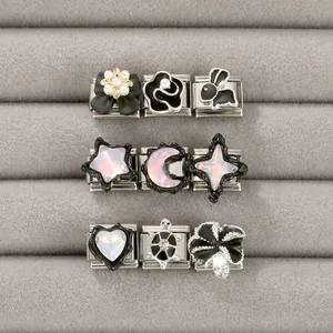 Macro view of stainless steel Italian charm links with star, moon, and animal motifs