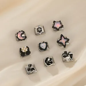 Detailed view of Italian charm links with moon, star, and animal designs in stainless steel.