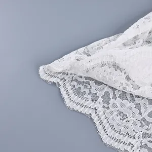 Detail van witte bloemenkant stof met delicate schulpranden voor elegante shirts