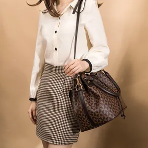 Large capacity printed bucket bag with brown geometric pattern and shoulder strap
