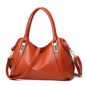 Elegant orange faux leather tote bag with large capacity and detachable strap.