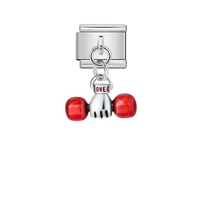 Close-up of Italian modular charm link with silver fist and red dumbbell pendant