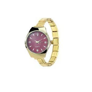 Detailed view of an Italian modular stainless steel watch with pink dial and gold strap