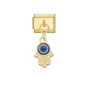 Close-up of gold Italian charm link with blue evil eye hamsa hand pendant