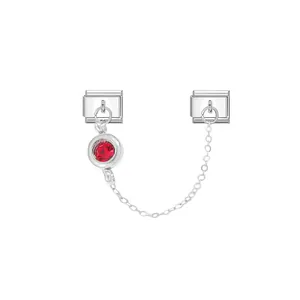 Detailed macro view of an Italian modular charm with a red birthstone and silver link chain