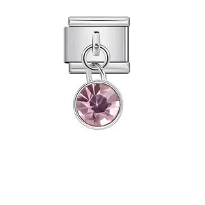 Close-up of Italian modular bracelet charm with a faceted pink birthstone pendant