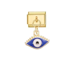 Detailed view of a gold Italian modular charm with a blue evil eye pendant