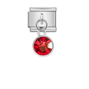 Close-up detail of a silver Italian charm link with a sparkling red gemstone pendant.