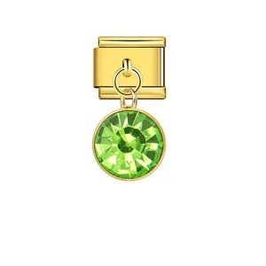 Detailed view of gold Italian modular charm with a peridot-like green crystal