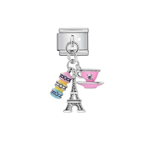 Detailed macro view of an Italian modular charm link with Eiffel Tower and macaron