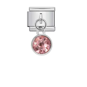 Detailed macro view of silver modular bracelet link with faceted pink crystal birthstone charm