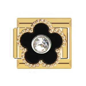 Detailed view of a gold-plated Italian charm featuring a black flower and central crystal