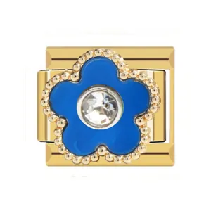 Close-up of gold-plated Italian charm with blue enamel flower and crystal center.