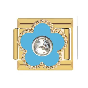Macro view of gold Italian charm featuring a blue flower with center crystal