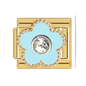 Close-up detail of gold Italian charm link featuring a blue flower and clear rhinestone