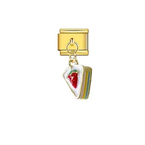 Close-up detail of a gold Italian charm module featuring a dangling rainbow cake slice pendant