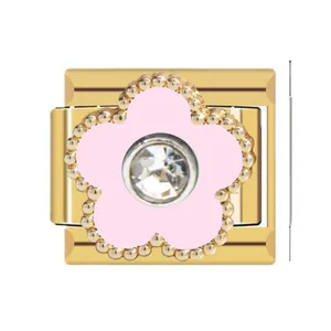 Detail view of a gold-toned Italian charm with a pink flower and crystal center