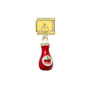 Close-up of a gold Italian modular charm with a cute red ketchup bottle dangle