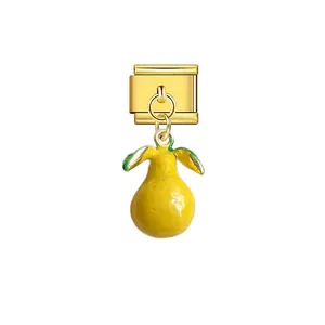 Detailed view of a golden Italian modular charm featuring a cute yellow pear pendant