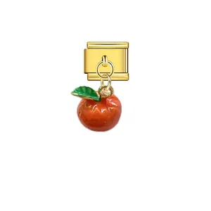 Detail showing a 9mm gold Italian modular link charm with a hanging red apple pendant.