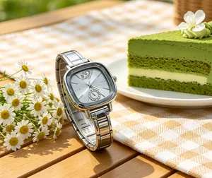Elegant silver square quartz watch with crystal accents on a sunny rustic table setting