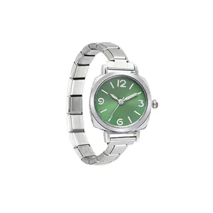 Detail view of a silver modular quartz watch featuring a vibrant green sunray dial.