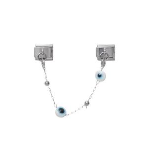 Close-up of modular Italian charm featuring blue evil eye beads and silver chain link.