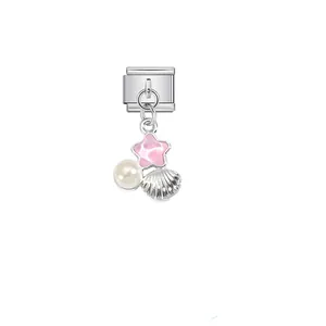 Detailed macro view of pink star, pearl, and seashell charm on stainless steel link