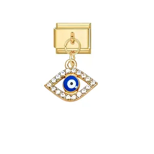Detailed view of gold Italian charm link featuring a sparkling blue evil eye pendant