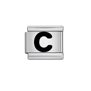 Macro detail of a silver stainless steel Italian charm link with a black enamel letter C