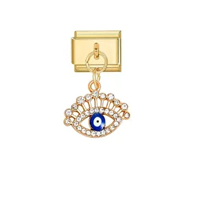 Detailed view of a gold Italian charm link with a sparkling blue evil eye pendant.