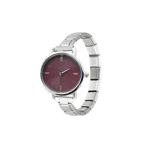 Detail shot of a round quartz watch with a burgundy spiral dial and modular steel strap