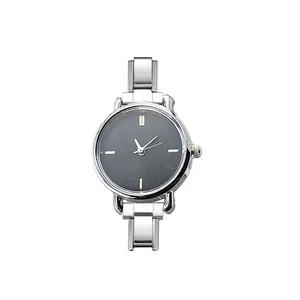 Detail view of a round quartz watch with black textured dial and silver stainless steel band