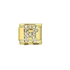 Close-up detail of a gold Italian charm link featuring a sparkling rhinestone letter R