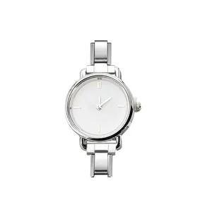 Detail of minimalist round quartz watch with silver stainless steel modular strap
