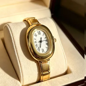 Detailed close-up of golden oval quartz watch with white Roman numeral dial
