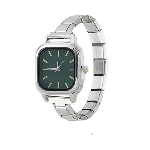 Close-up of a minimalist silver Italian modular quartz watch with a dark green dial