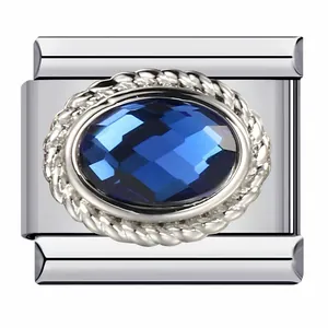Close-up of Italian modular charm link with blue faceted gemstone and rope border