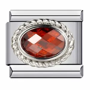 Macro view of Italian charm module with oval red gemstone and silver rope border