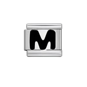Close-up detail view of a silver modular charm featuring a bold black enamel letter M