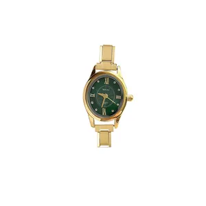 Close-up of elegant gold oval quartz watch featuring a green dial and modular strap