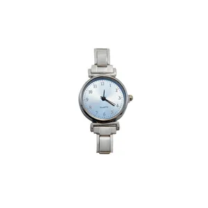 Detail view of a minimalist quartz watch with a light blue sunray dial and silver modular strap