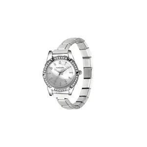 Detailed close-up showing the rhinestone bezel and silver link strap of a woman's wristwatch