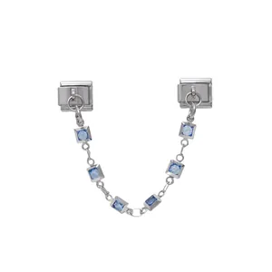 Detailed view of silver modular bracelet safety chain with square blue stones