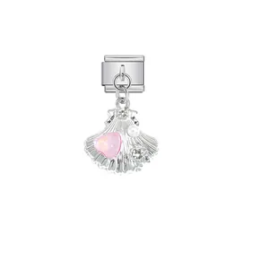 Detailed view of a silver shell charm link with a pink heart stone for modular jewelry.