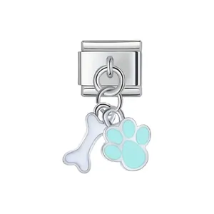 Close-up of stainless steel dog bone and light blue paw print dangle charm module for DIY bracelet