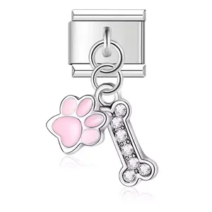 Close-up view of a stainless steel dog paw and crystal bone charm for modular bracelets.