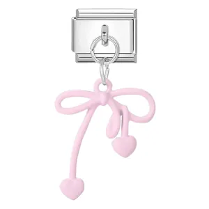 DIY modular charm featuring a pink bow and heart pendant on a silver-tone base.
