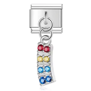 Close-up detail of stainless steel modular charm with vibrant multi-colored rhinestones